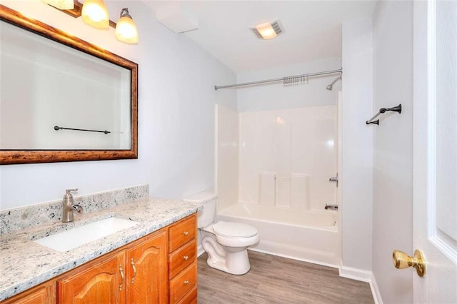662 Shady Willow Ln, Loganville, GA 30052 - full bath with toilet, wood finished floors, vanity, and shower / tub combination