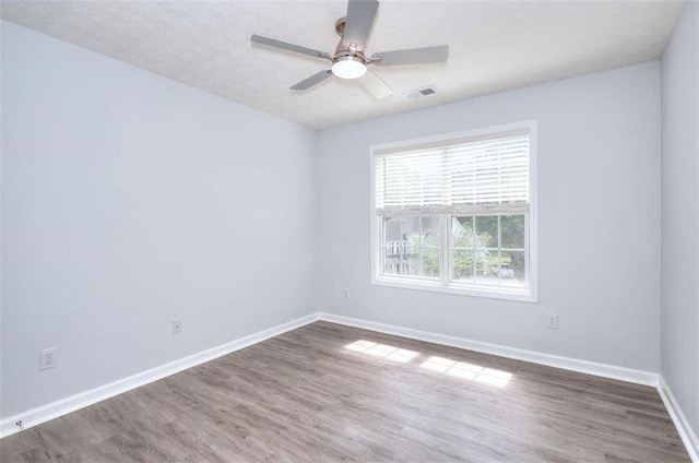 662 Shady Willow Ln, Loganville, GA 30052 - unfurnished room with wood finished floors, baseboards, and a ceiling fan