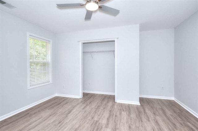 662 Shady Willow Ln, Loganville, GA 30052 - unfurnished bedroom with wood finished floors, a closet, baseboards, and ceiling fan