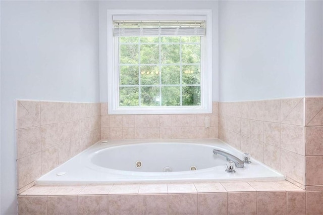 662 Shady Willow Ln, Loganville, GA 30052 - bathroom with healthy amount of natural light and a tub with jets