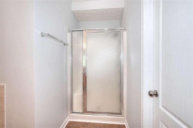 662 Shady Willow Ln, Loganville, GA 30052 - full bath featuring a stall shower, tile patterned floors, and baseboards