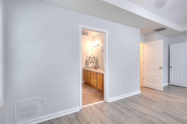 662 Shady Willow Ln, Loganville, GA 30052 - unfurnished bedroom with light wood-type flooring, baseboards, and connected bathroom