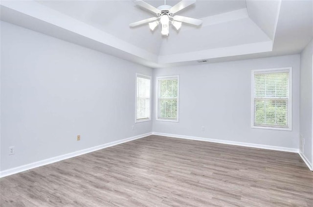 662 Shady Willow Ln, Loganville, GA 30052 - unfurnished room featuring a raised ceiling, healthy amount of natural light, wood finished floors, and ceiling fan