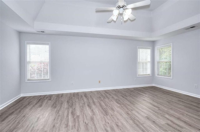 662 Shady Willow Ln, Loganville, GA 30052 - spare room featuring a tray ceiling, wood finished floors, baseboards, and ceiling fan