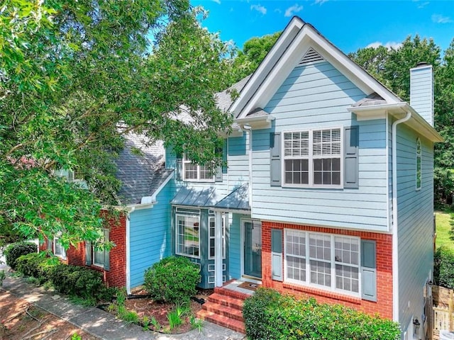 662 Shady Willow Ln, Loganville, GA 30052 - view of front of home with a chimney and brick siding