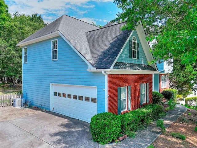 662 Shady Willow Ln, Loganville, GA 30052 - view of side of property with a shingled roof, driveway, cooling unit, brick siding, and fence