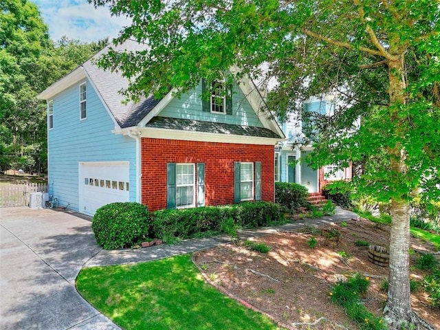 662 Shady Willow Ln, Loganville, GA 30052 - view of front facade featuring concrete driveway, a shingled roof, brick siding, fence, and a garage