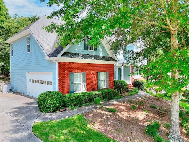 662 Shady Willow Ln, Loganville, GA 30052 - view of front of house with concrete driveway, central AC, roof with shingles, and brick siding