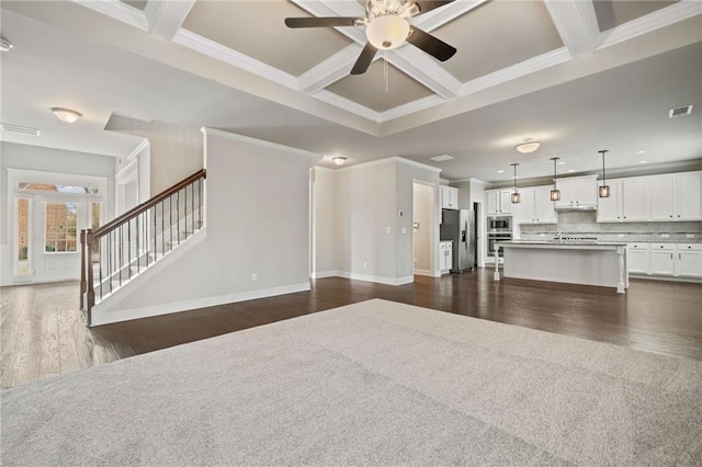 unfurnished living room with visible vents, beamed ceiling, a ceiling fan, coffered ceiling, and dark wood-style flooring