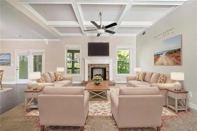 living area featuring coffered ceiling, visible vents, a wealth of natural light, and ceiling fan