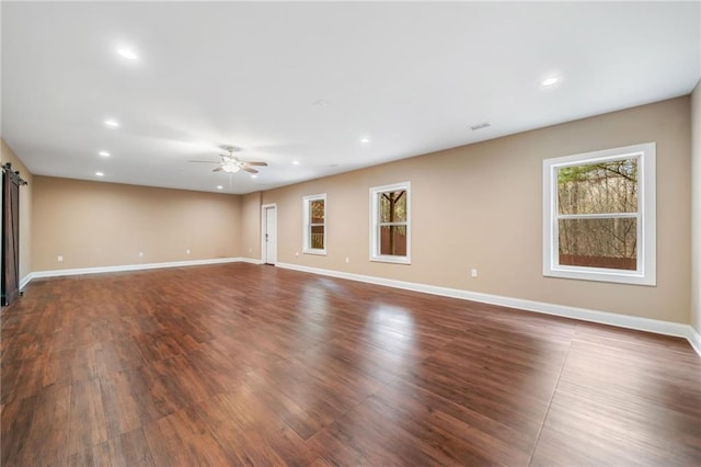 empty room with a wealth of natural light, baseboards, and a ceiling fan