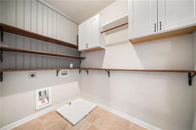 clothes washing area with hookup for an electric dryer, washer hookup, cabinet space, baseboards, and gas dryer hookup