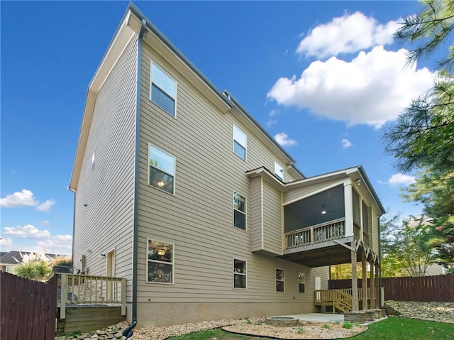 rear view of house with a patio and fence