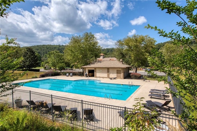 pool with fence and a patio area