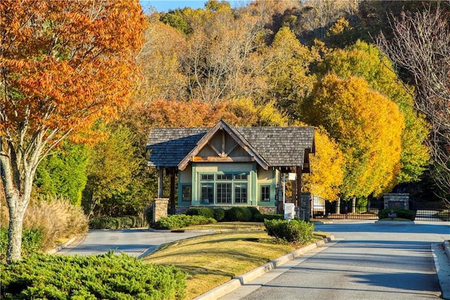 view of front of property featuring stone siding, a gate, and fence