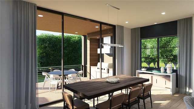 dining space featuring wood finished floors and recessed lighting