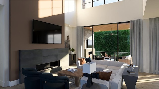 living area featuring wood finished floors and a towering ceiling