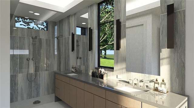 bathroom with double vanity, a sink, and a walk in shower