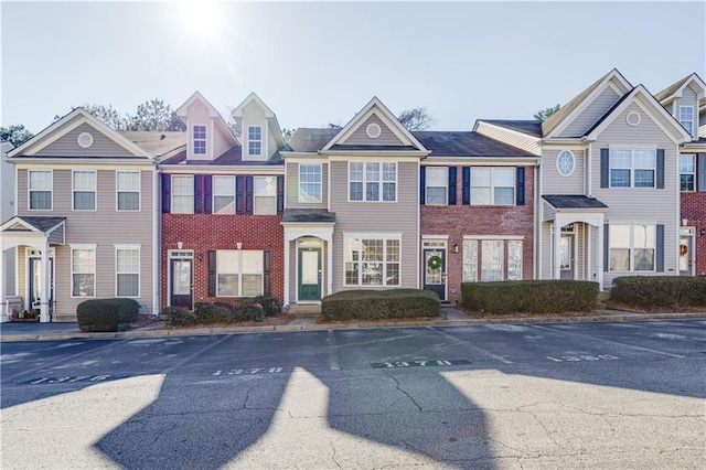 townhome / multi-family property with brick siding