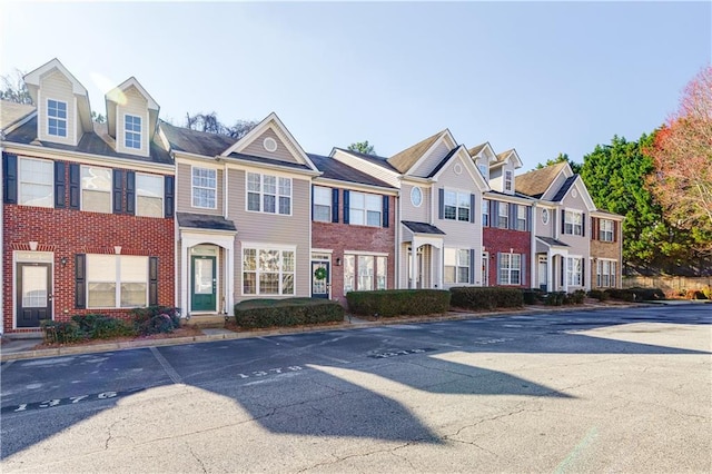 multi unit property featuring a residential view and brick siding