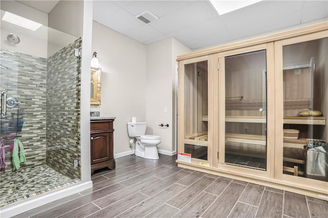 740 Creek Wind Ct, Duluth, GA 30097 - full bath with vanity, toilet, a stall shower, wood tiled floors, and baseboards