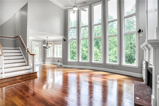 740 Creek Wind Ct, Duluth, GA 30097 - unfurnished living room with a towering ceiling, a fireplace, baseboards, and plenty of natural light
