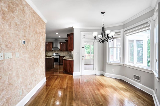 740 Creek Wind Ct, Duluth, GA 30097 - unfurnished dining area featuring wood finished floors, a chandelier, baseboards, and ornamental molding