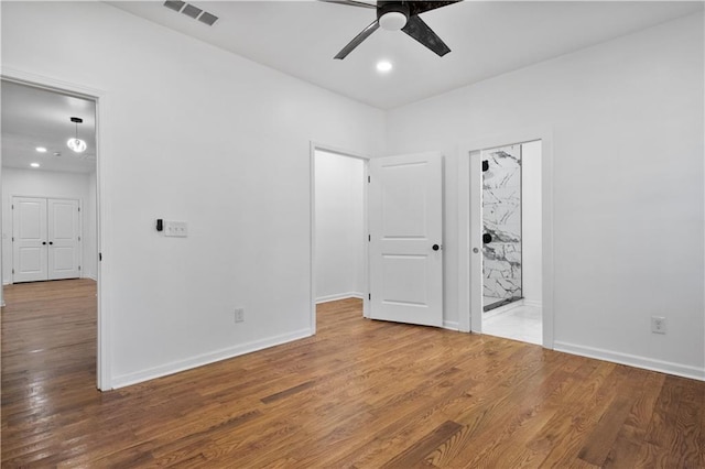 unfurnished room with hardwood / wood-style floors and ceiling fan