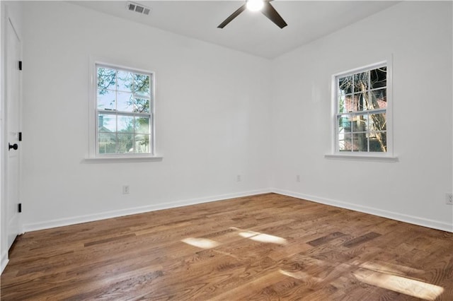 spare room with ceiling fan and hardwood / wood-style flooring