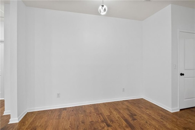 empty room with dark hardwood / wood-style flooring