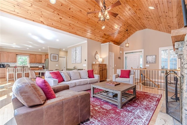 living room featuring light hardwood / wood-style floors, wood ceiling, high vaulted ceiling, and ceiling fan