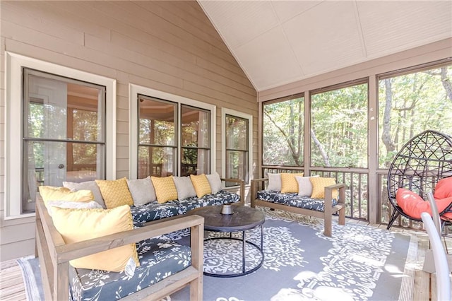 sunroom featuring a healthy amount of sunlight and vaulted ceiling