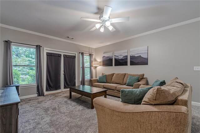 carpeted living room featuring ornamental molding and ceiling fan