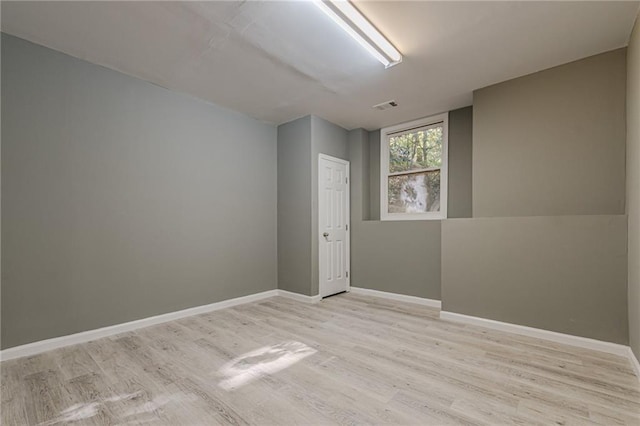 spare room featuring light hardwood / wood-style floors