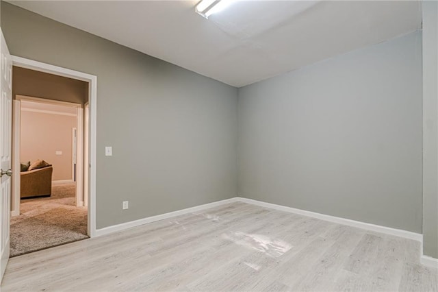 spare room with light hardwood / wood-style flooring