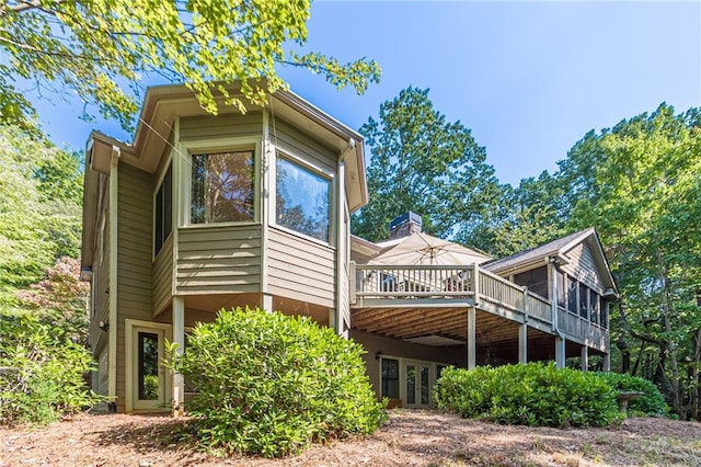 view of side of home featuring a wooden deck