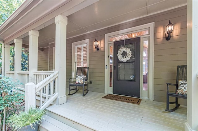 view of exterior entry featuring covered porch