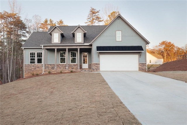 view of front of property with covered porch and a garage