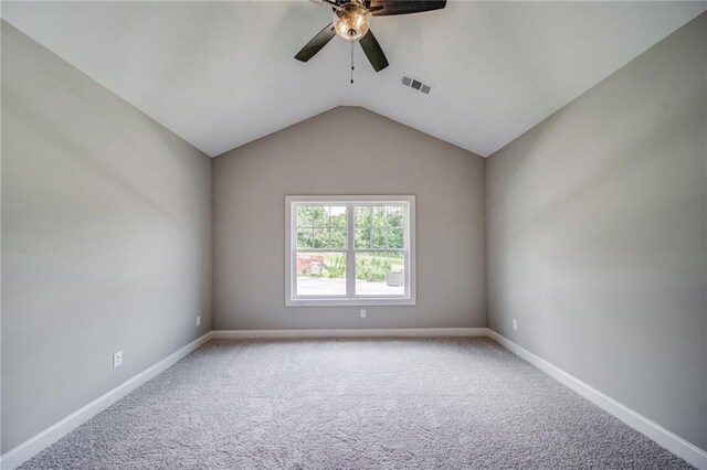 361 Creek Wood Park Dr, Ball Ground, GA 30107 - spare room with a ceiling fan, carpet floors, vaulted ceiling, and baseboards