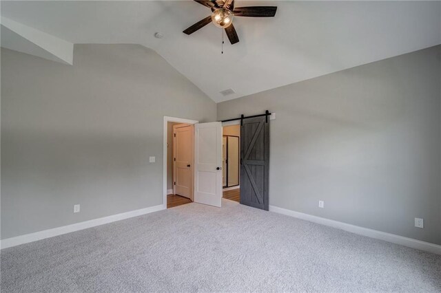 361 Creek Wood Park Dr, Ball Ground, GA 30107 - unfurnished bedroom with carpet flooring, baseboards, a barn door, ceiling fan, and high vaulted ceiling