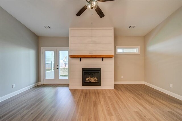 361 Creek Wood Park Dr, Ball Ground, GA 30107 - unfurnished living room with wood finished floors, ceiling fan, baseboards, a large fireplace, and french doors