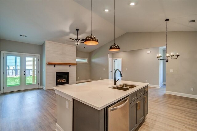 361 Creek Wood Park Dr, Ball Ground, GA 30107 - kitchen with stainless steel dishwasher, a sink, light wood finished floors, baseboards, and lofted ceiling