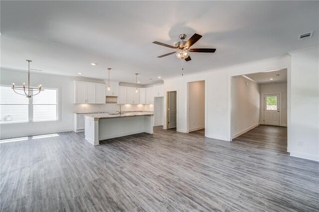 361 Creek Wood Park Dr, Ball Ground, GA 30107 - kitchen featuring open floor plan, white cabinetry, wood finished floors, baseboards, and a kitchen island with sink