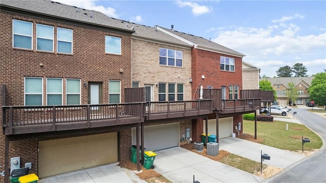 705 Ayala Pl, Alpharetta, GA 30004 - back of house featuring driveway, a residential view, brick siding, central AC, and an attached garage