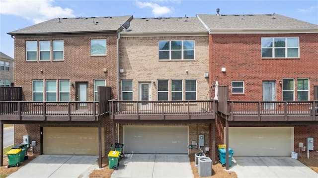 705 Ayala Pl, Alpharetta, GA 30004 - back of house with a garage, driveway, and brick siding