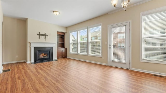 705 Ayala Pl, Alpharetta, GA 30004 - unfurnished living room with visible vents, baseboards, built in features, and light wood-type flooring