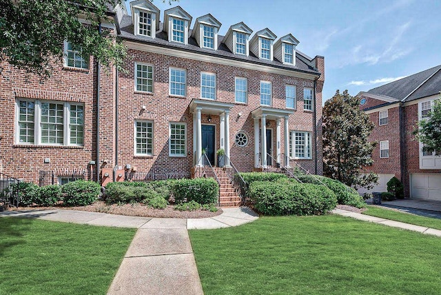 colonial-style house with brick siding and a front lawn