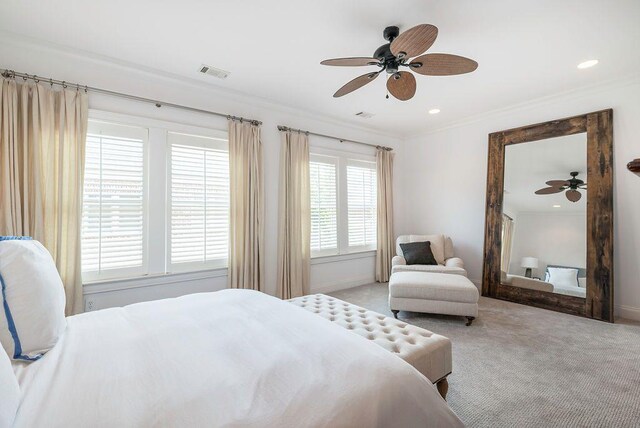 carpeted bedroom featuring crown molding and ceiling fan