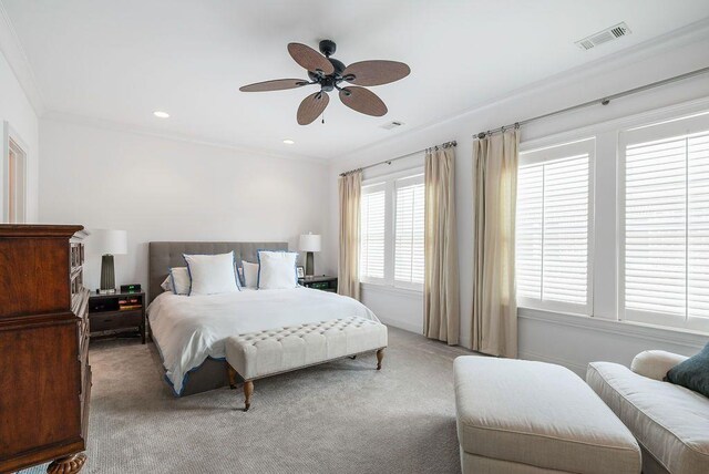 carpeted bedroom featuring ornamental molding and ceiling fan