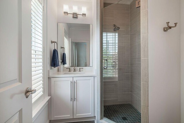 bathroom featuring an enclosed shower and vanity